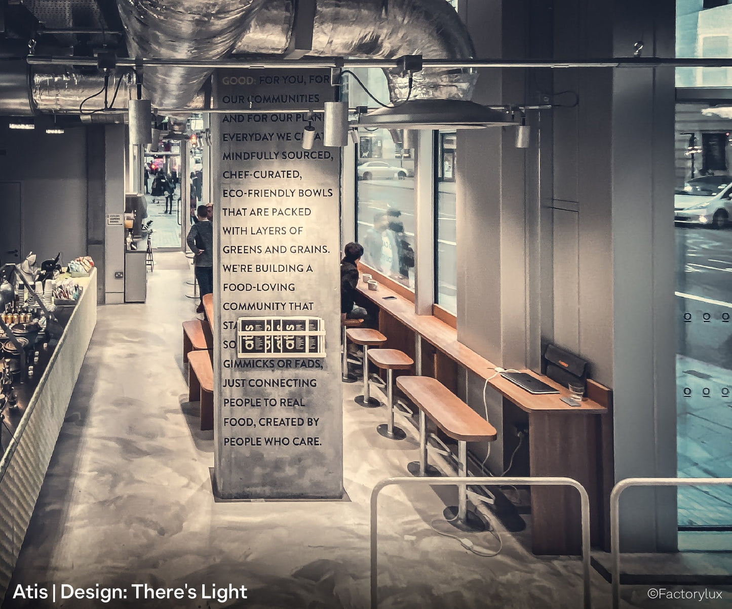 Food display and counter at Atis, a plant-based restaurant, with ceiling mounted conduit lighting and natural spotlights