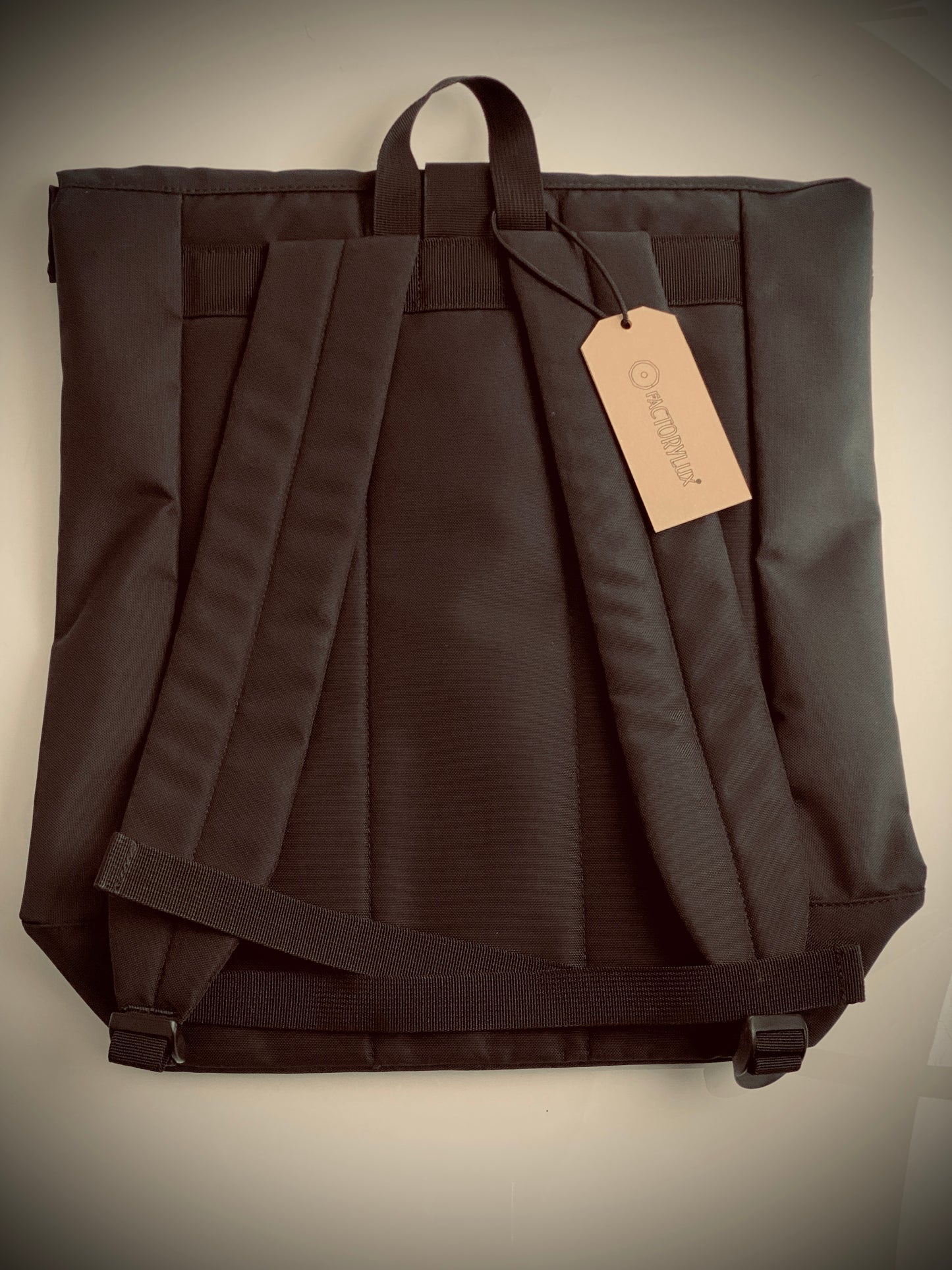 Rear view of Factorylux 20 litre, roll top, black recycled polyester bag. 