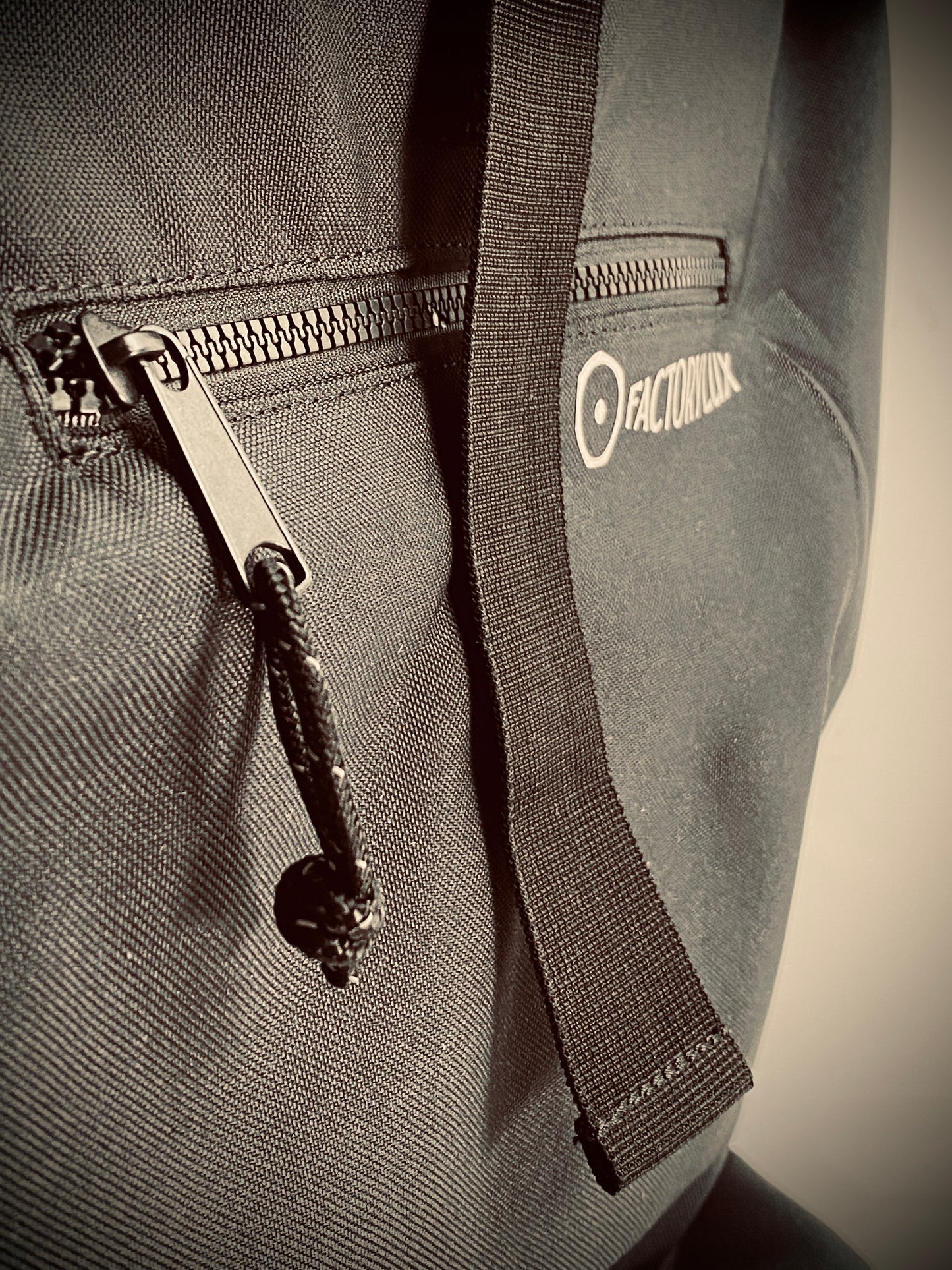 Zip detail of Factorylux 20 litre, roll top, black recycled polyester bag.