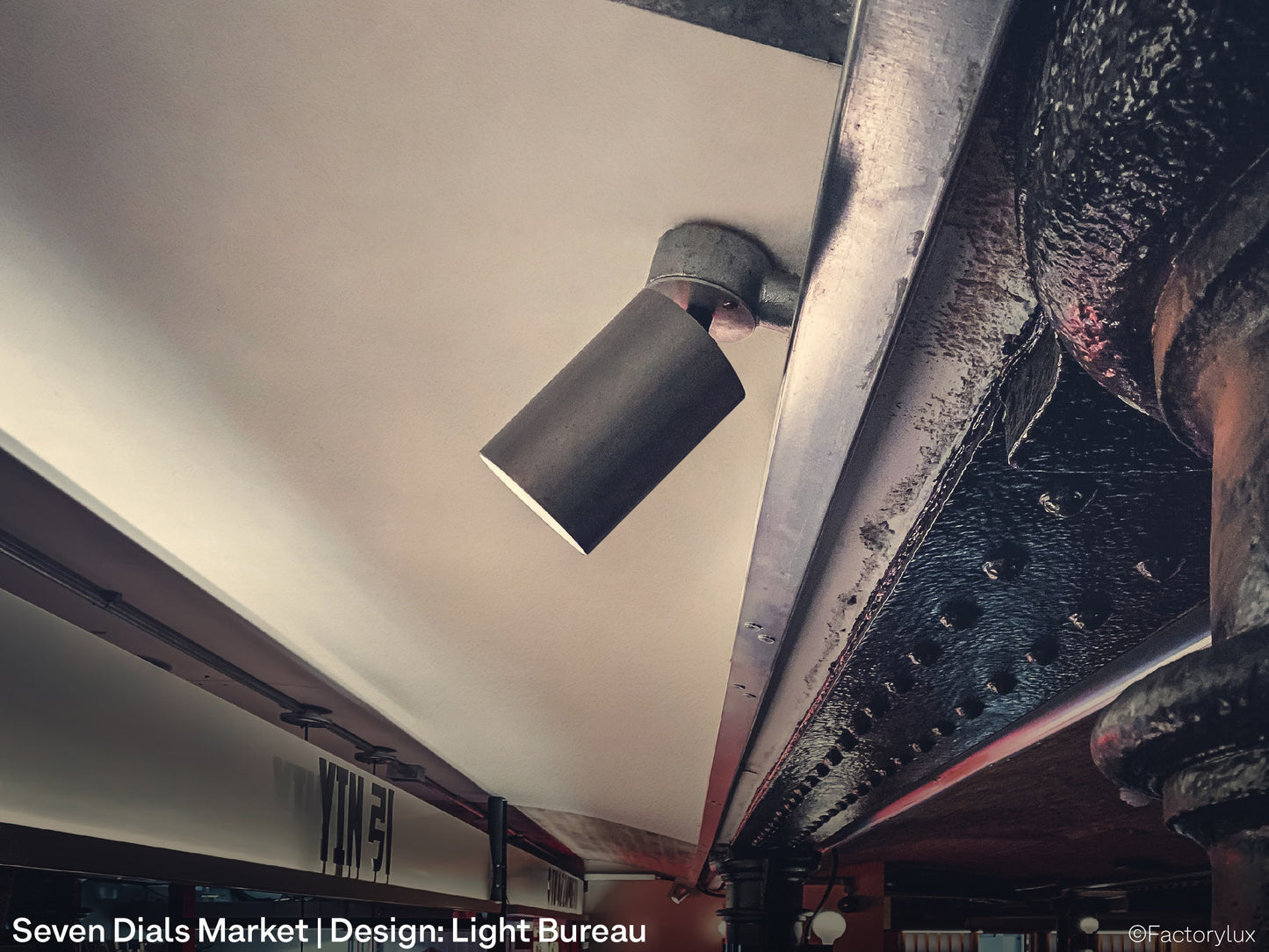 Close up of a paint-free, VOC-free, ceiling mounted architectural spotlight at Seven Dials food market in London