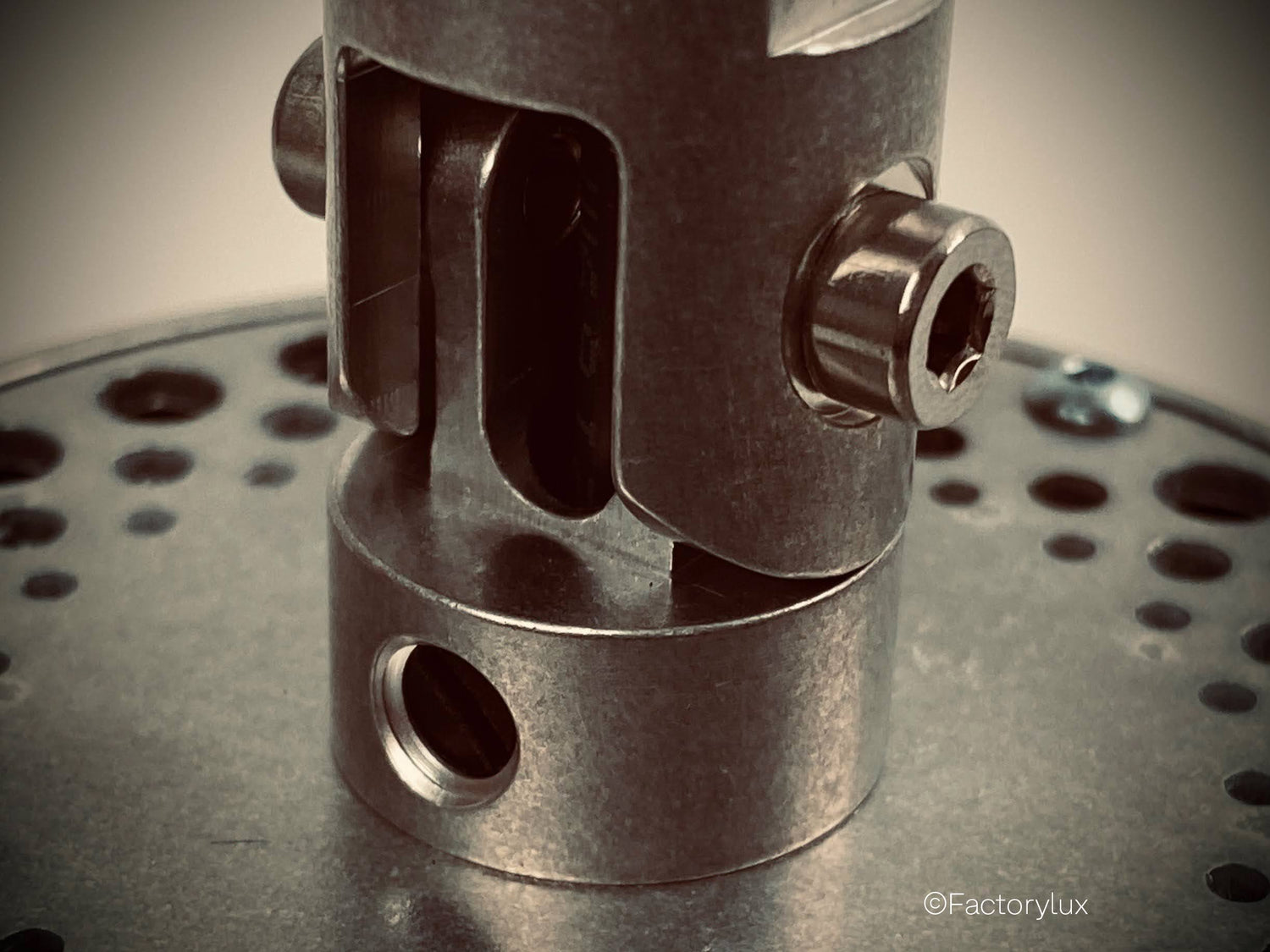 Close up of an environmentally friendly architectural spotlight adjustable lock-off joint, milled from pure natural aluminium
