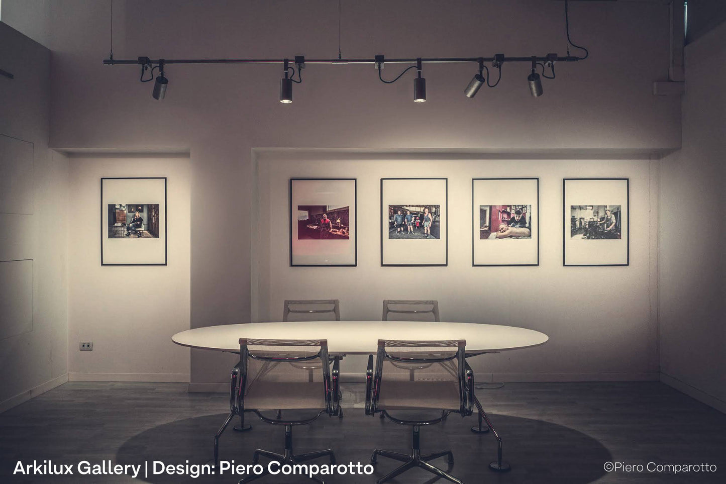 Paintings and photography at a fine art gallery in Italy, illuminated by softbeam spotlights on lighting track