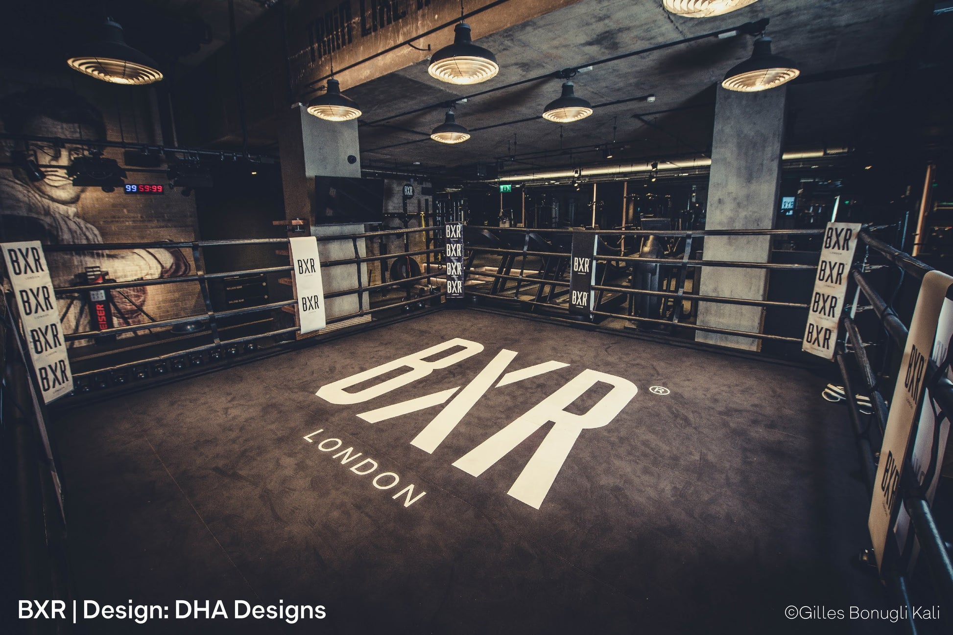 BXR modern gym interior with open brickwork, architectural pendant lights and concentric louvres over boxing ring