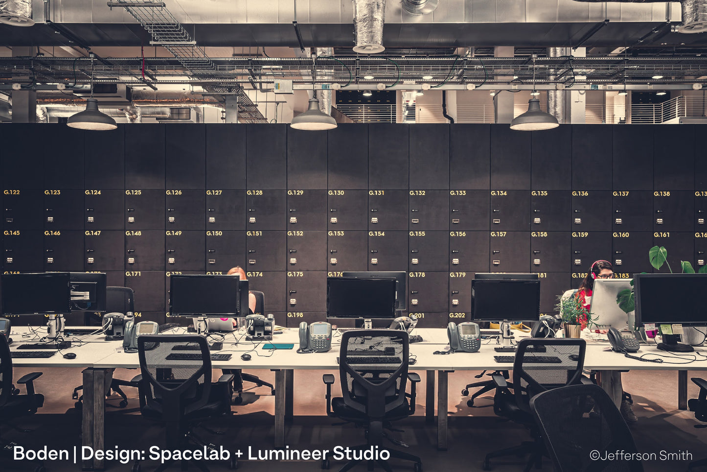 Contemporary office workers in Boden's fashionable London HQ with architectural pendant lighting