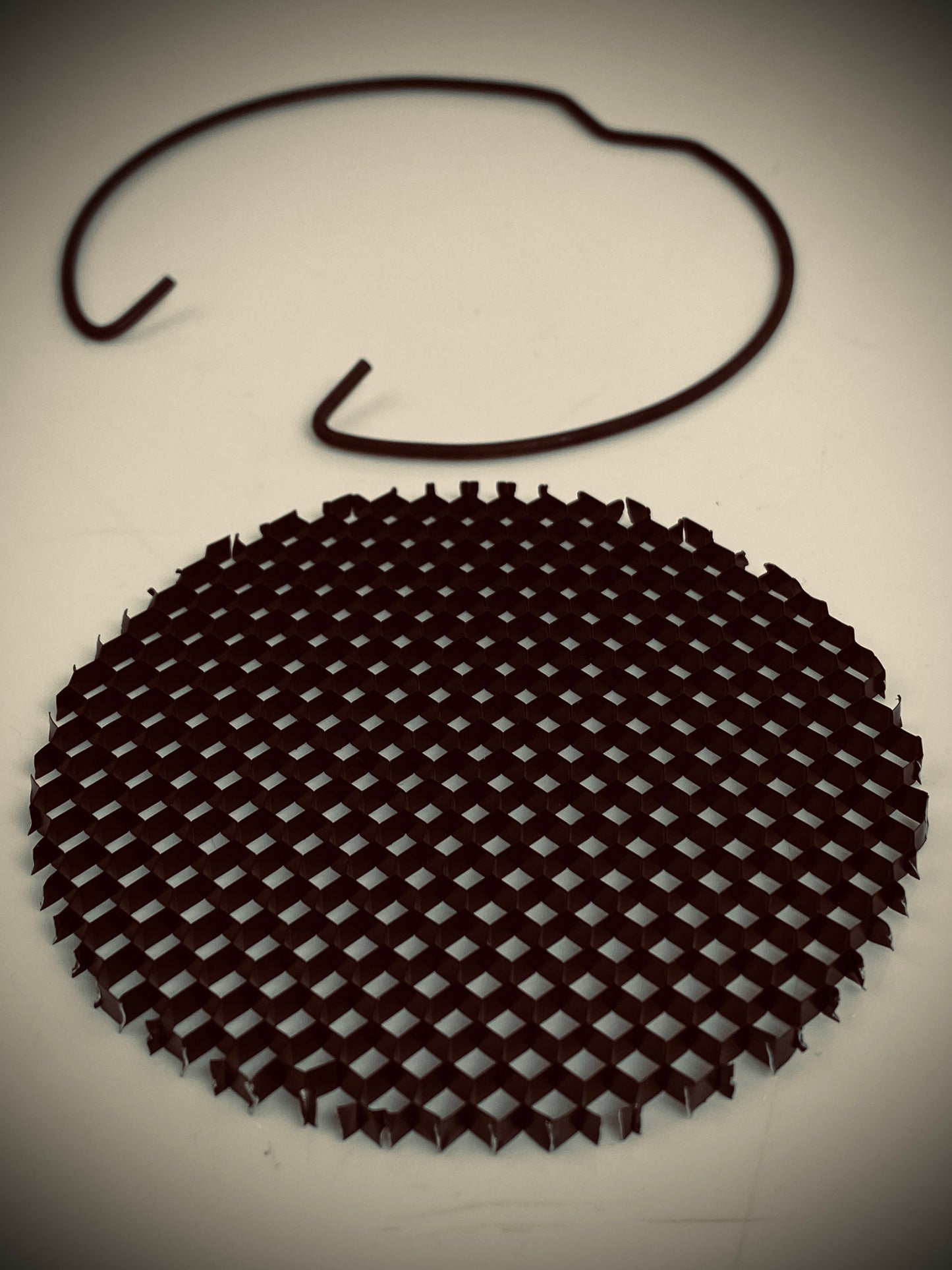 Circular, black anodised aluminium honeycomb louvre clips