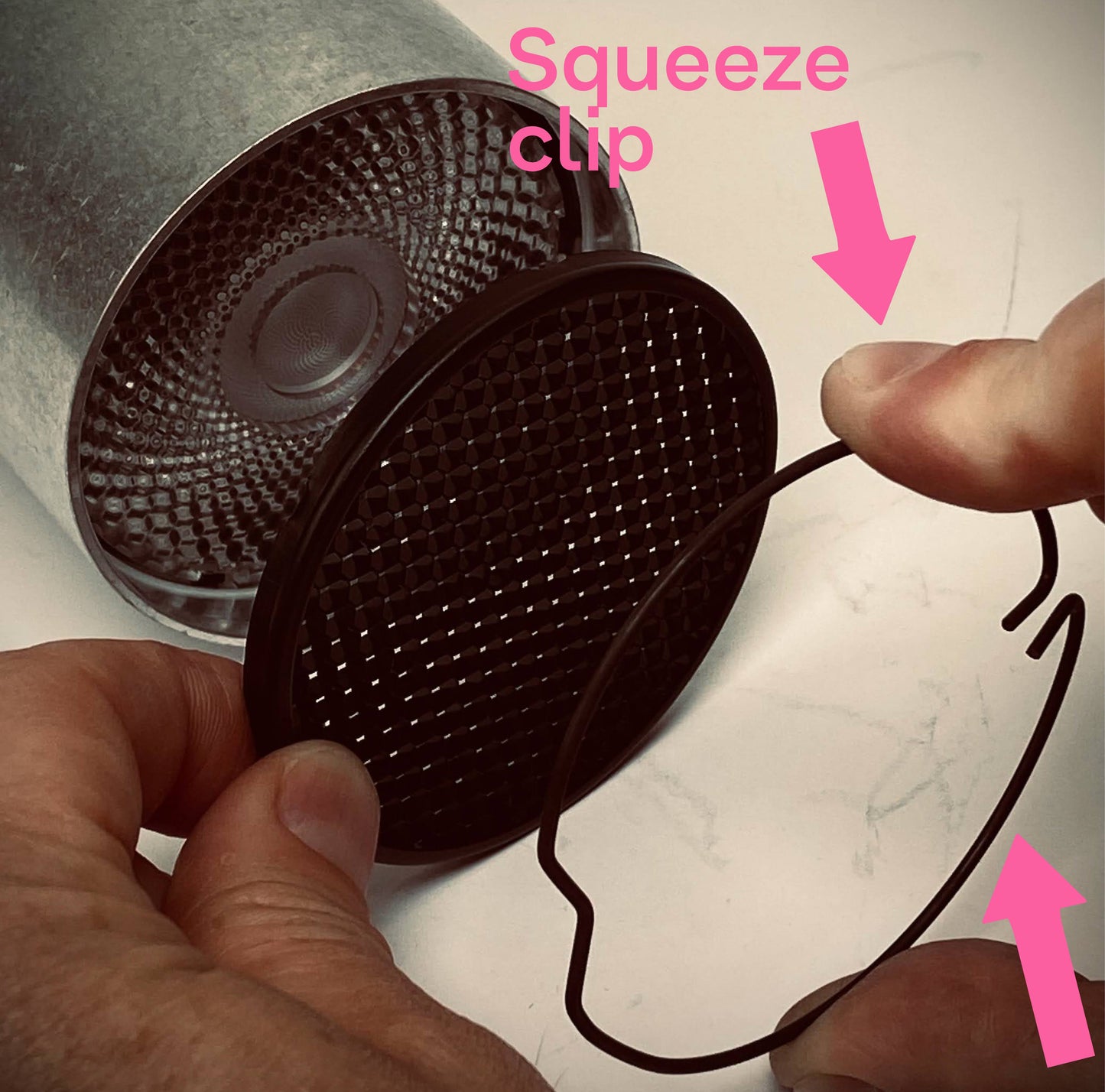 Easy squeeze clip to attach honeycomb louvre onto  a Factorylux Ninety-Nine Spotlight