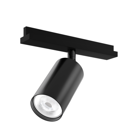 A sustainable, black, architectural spotlight that's designed for circular economy, on a track adaptor with integral driver