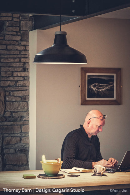 Original timber beams, subtle track lighting and spotlights at Gagarin's RIBA award stone barn conversion in Yorkshire