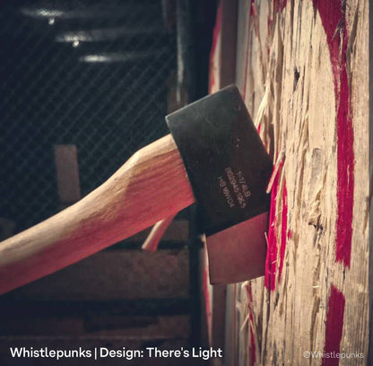 An axe head, stuck in red wooden target at Whistlepunks, with warm LED spotlights, louvres and glare control